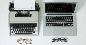 Content worfklow using github and markdown with a typewriter and laptop side by side