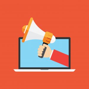 Illustration of a hand holding a megaphone coming out of a laptop screen